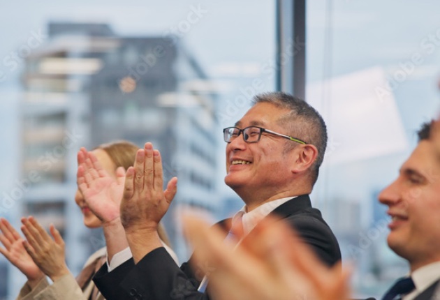 Attendees applauding during a training session